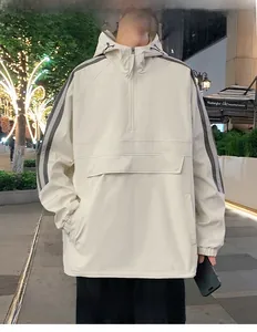 Detail of light beige hooded jacket with grey sleeve stripes and large front flap pocket