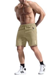 Detail of khaki quick-dry athletic shorts featuring elastic waist and zip pockets