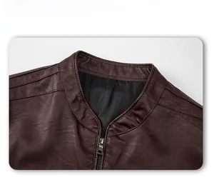Detailed close-up of dark brown leather jacket with stand collar and metal zipper