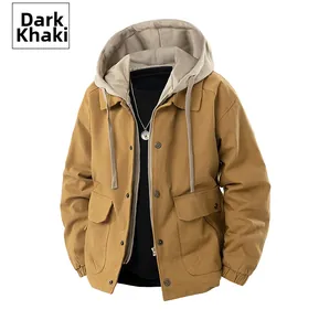 Detail of dark khaki hooded jacket with utility pockets and grey inner hood lining
