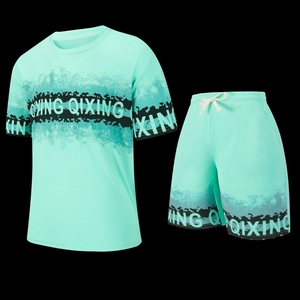 Detail view of mint green mesh sports set with QIXING print and breathable fabric texture