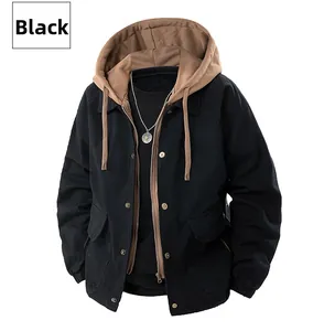 Detail of hooded work jacket showing black canvas fabric and metallic snap buttons