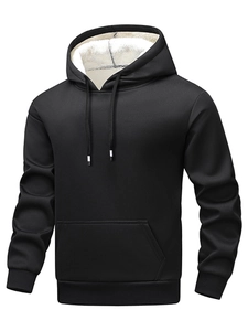 Detail of men's black hoodie with thick white faux shearling lining and kangaroo pocket