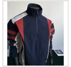 Detail of color block jacket featuring high neck collar and durable polyester texture