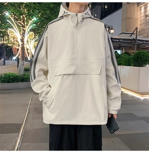 Detail of off-white hooded windbreaker jacket featuring half-zip and utility front pocket