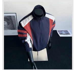 Detail of color block sports jacket with navy blue, red and white windbreaker fabric