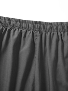 Detailed macro view of elastic waistband with fine stitching on dark grey sports shorts