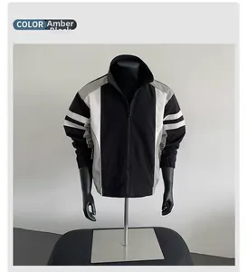 Detailed shot of men's color-block jacket in amber black with stand collar and zipper