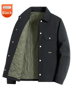 Detail of black quilted men's jacket with olive green diamond lining and lapel collar