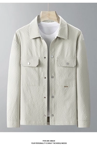 Close-up of beige waffle texture fabric on men's jacket with pocket and button detail