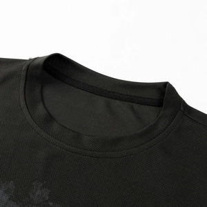 Detail of black crew neck T-shirt featuring honeycomb breathable mesh fabric texture