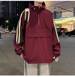 Detail of burgundy street jacket with white stripes on sleeves and half-zip collar