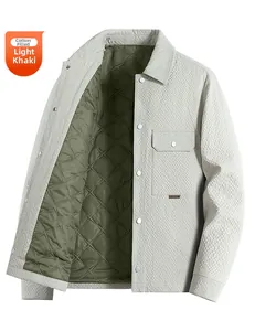 Detail of light khaki quilted jacket showing interior green lining and metal snap pockets