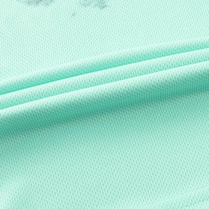 Close-up of mint green breathable mesh fabric showing the diamond texture and soft drape