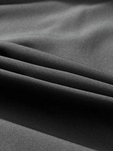 Detailed close-up of dark gray twill fabric showing the matte texture and durable weave