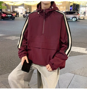 Close-up of the burgundy hoodie jacket featuring contrast black and white sleeve webbing