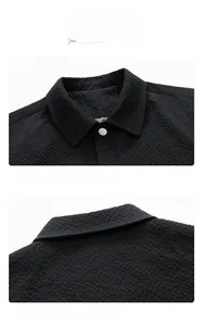 Detail of black seersucker jacket with comfortable lapel and textured fabric