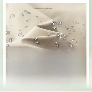Close-up of water-repellent khaki techwear fabric showing texture and water droplets