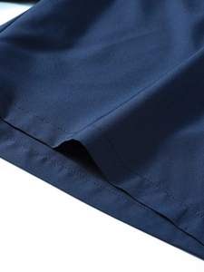 Close-up of navy blue quick-dry fabric showing detailed double-needle stitched hem and texture