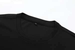 Close-up of black breathable mesh crew neck t-shirt with size XL label on the neckline