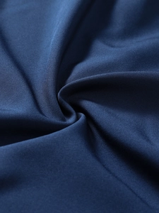 Close-up of navy blue quick-dry fabric texture with soft folds and matte finish