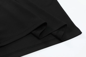 Detail of breathable mesh fabric and neat double-needle stitching on black sports set