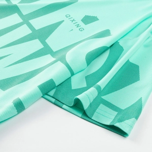 Detailed close-up of mint green breathable mesh fabric with dark green geometric pattern