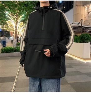 Outdoor street style view of casual windbreaker jacket with sleeve stripes and drawstring hood