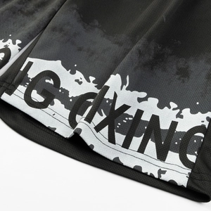 Close-up of black mesh athletic shorts featuring Boxing text and white splattered print