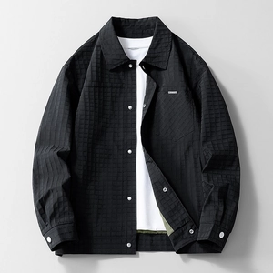 Men's black waffle texture jacket with classic lapel and silver snap buttons on grey background
