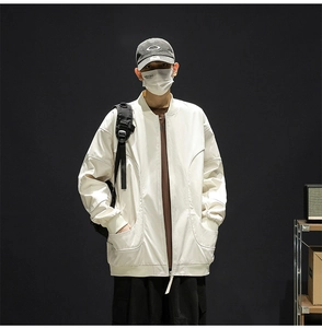 Detail of off-white bomber jacket with large double pockets and ribbed cuffs