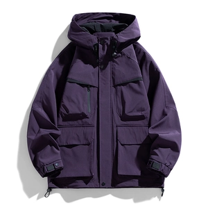 Detailed view of the functional purple outdoor jacket with utility flap pockets and drawstring