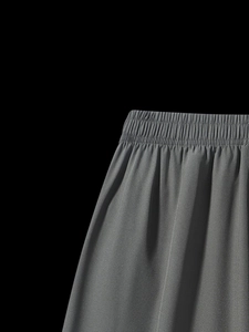 Detailed macro view of gray elastic waistband and breathable quick-dry athletic fabric