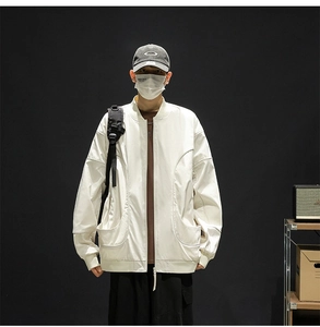 Detail of white water-repellent baseball jacket with curved seams and large patch pockets