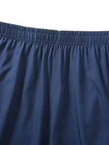 Detailed view of elastic waistband and stitching on navy quick-dry sports shorts