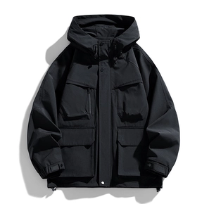 Detail view of black functional hooded jacket with four large cargo pockets and drawstrings
