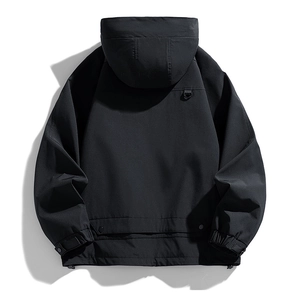 Rear view of black functional hooded jacket with waterproof fabric and D-ring detail