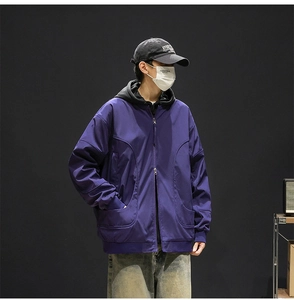 Detail of deep purple jacket featuring a two-way zipper and trendy drop shoulder fit