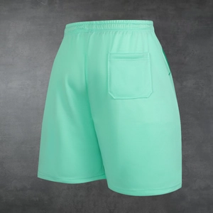 Detail view of mint green mesh athletic shorts showing elastic waistband and back pocket