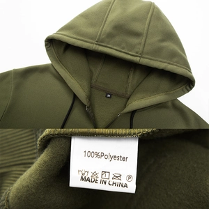 Detailed macro view of olive green hoodie neckline with M size tag and 100% polyester label