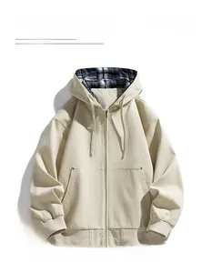 Detail of light beige hooded jacket featuring blue and white plaid flannel lining inside