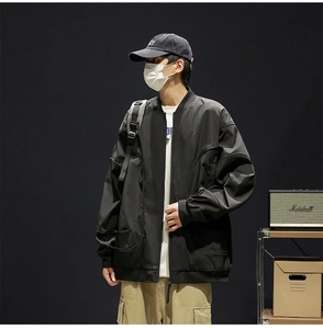 Detail shot of black bomber jacket with stand collar and large utility pockets