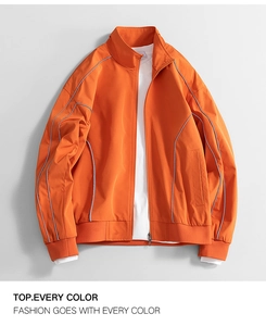 Macro shot of water-repellent orange jacket detailing reflective stripes and high neck collar