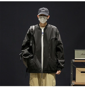 Detail of water-repellent bomber jacket showing curved stitching and functional pockets