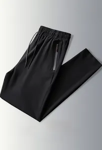 Detail of elastic drawstring waistband and side pocket on black ice silk trousers