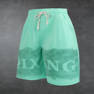 Mint green mesh sports shorts with dark green tie-dye print and DIXING logo