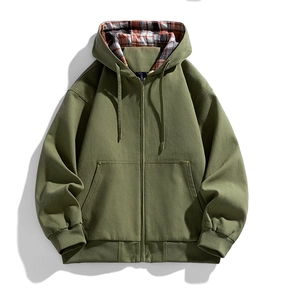 Detail of olive green hooded jacket with classic red plaid lining and durable metal zipper