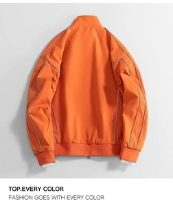 Back view of orange windbreaker jacket featuring silver piping and ribbed cuffs details