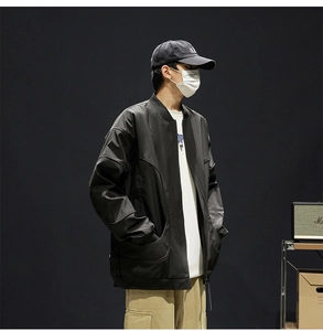 Detail of water-resistant black bomber jacket with stand collar and zipper closure
