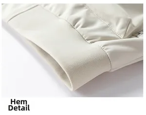 Detailed view of the elastic ribbed hem and premium fabric of the beige work jacket